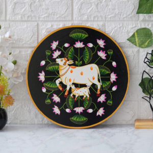 This beautiful pichwai painting features a mother cow and her calf nuzzling each other, surrounded by a vibrant array of flowers.